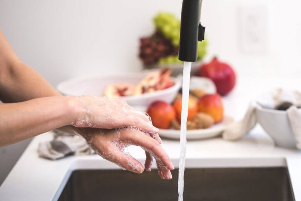 soapy hands under a faucet