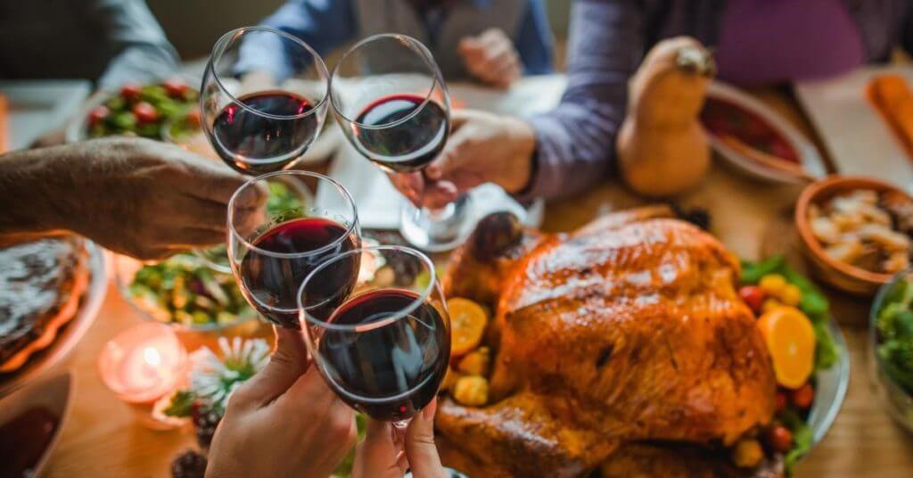 Glasses of wine above a turkey feast