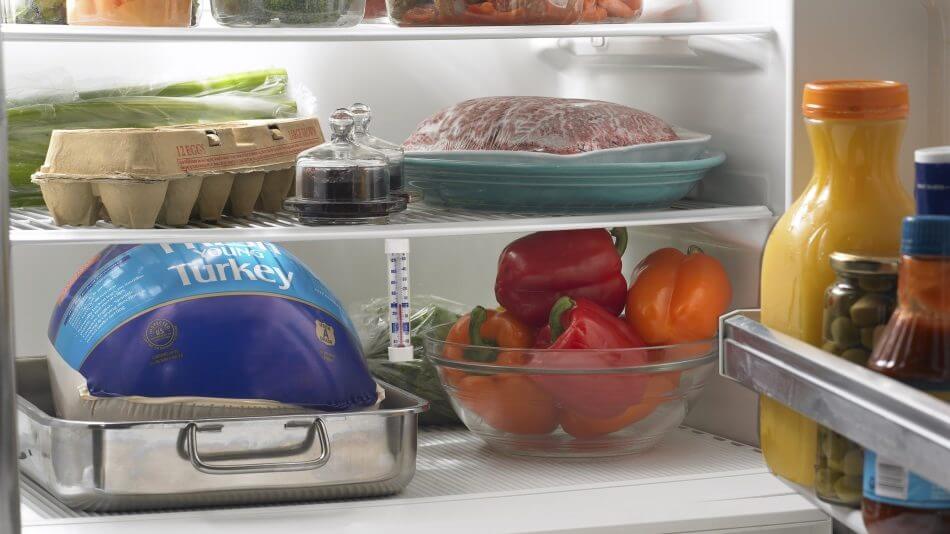turkey thawing on a refrigerator shelf