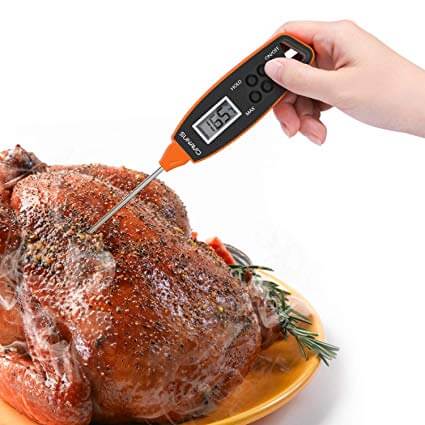 digital meat thermometer in a roasted turkey 