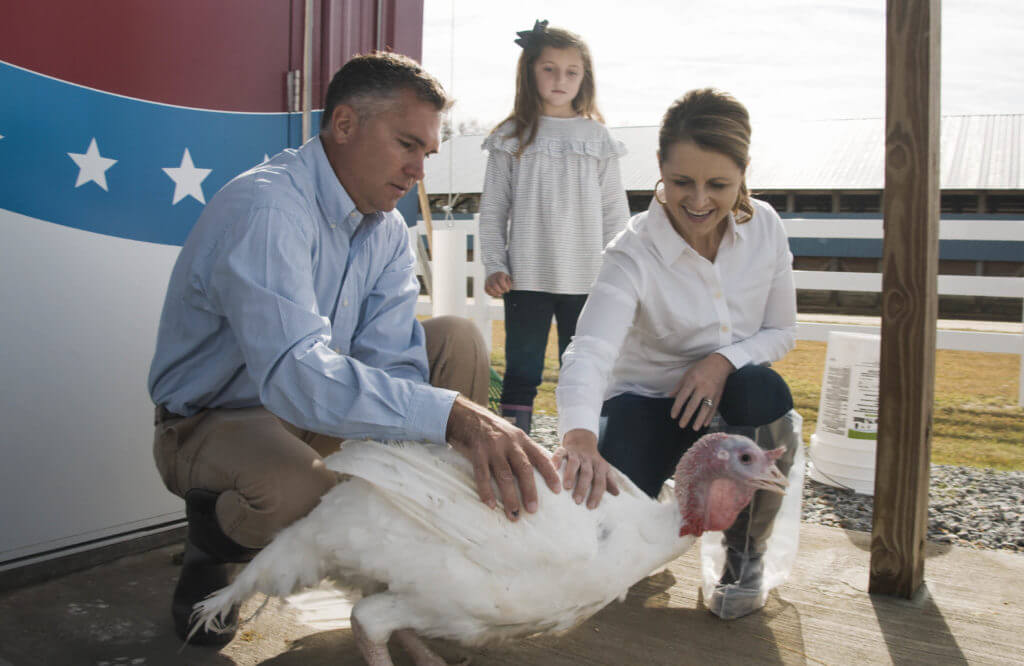Turkey farmer and family with a presidential turkey 