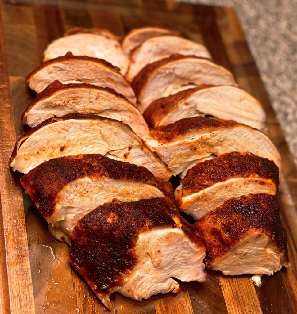 brined smoked Turkey Breast sliced on a cutting board
